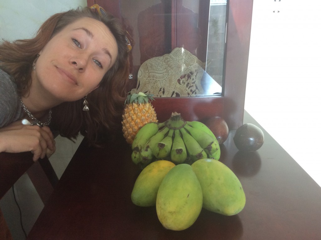 Ashley poses with fruits from the local outdoor market